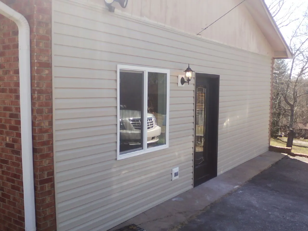 New vinyl siding and entry door on a room addition in Woods Hole